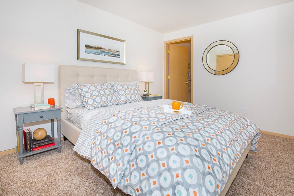 a bedroom with a bed and a mirror